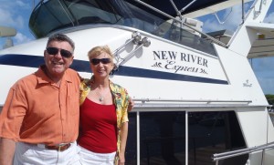 Photo of happy customers in front of boat.