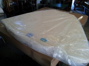 Image of a custom mattress wrapped and ready for shipping.